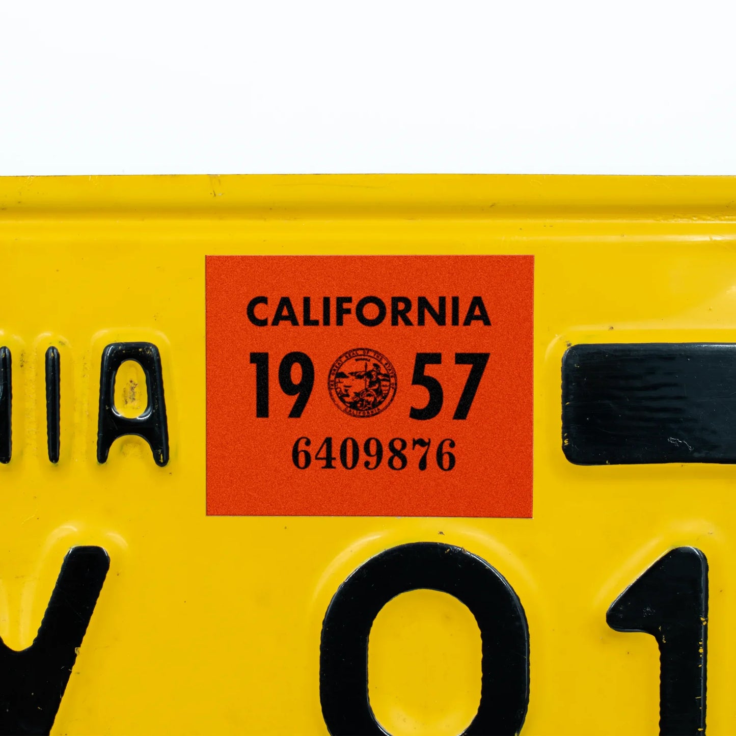 California license plate 1957 year sticker applied to yellow California plate — YOM Series