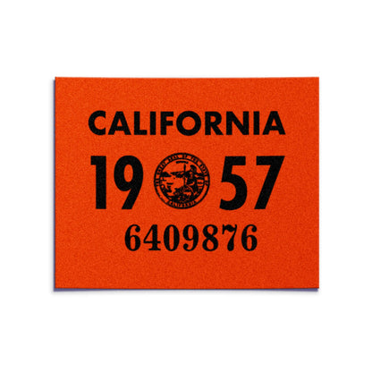 California license plate 1957 year sticker — YOM Series — reproduction shown on white background