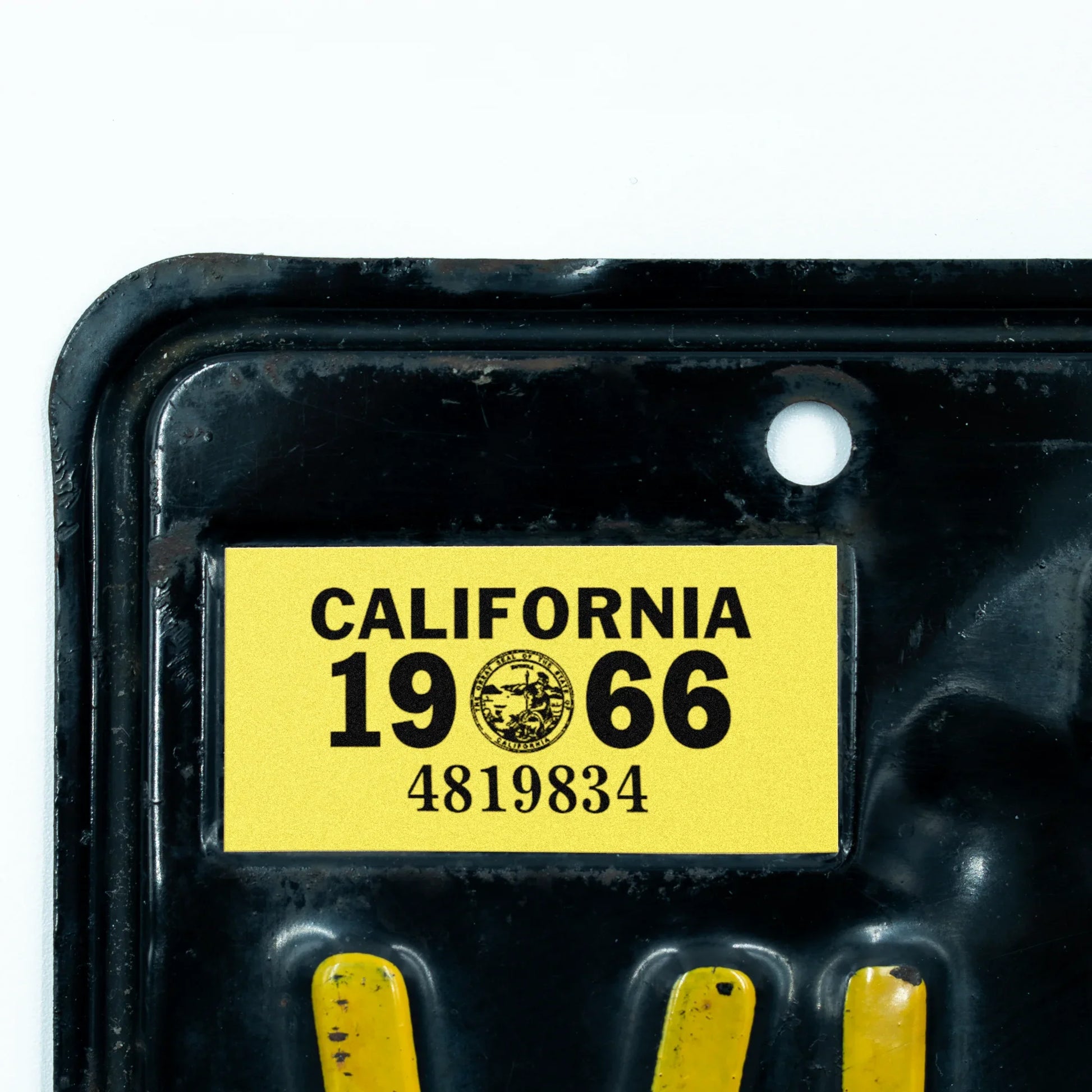 California license plate 1966 year sticker applied to upper corner of black California plate — YOM Series