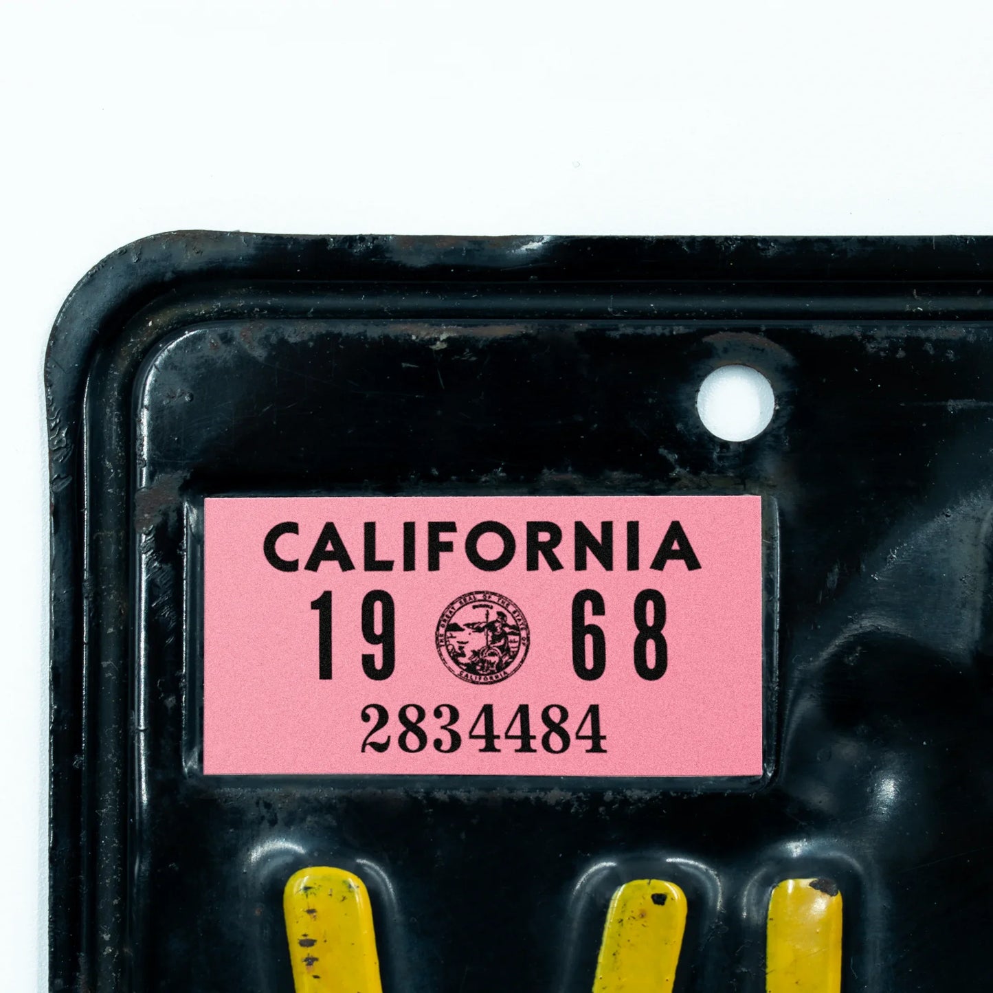 California license plate 1968 year sticker applied to upper corner of black California plate — YOM Series