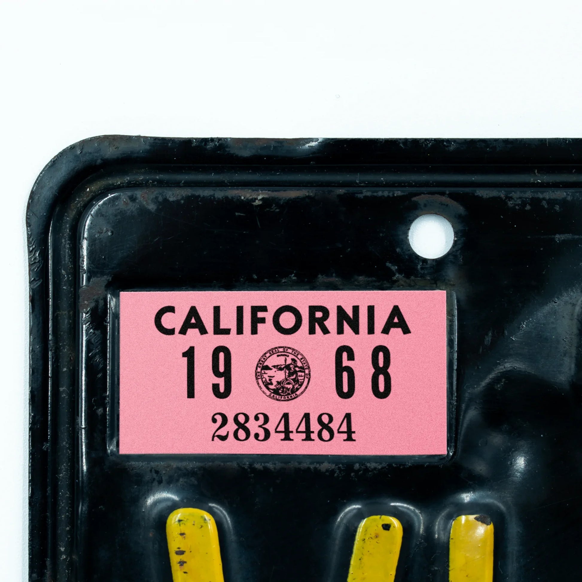 California license plate 1968 year sticker applied to upper corner of black California plate — YOM Series