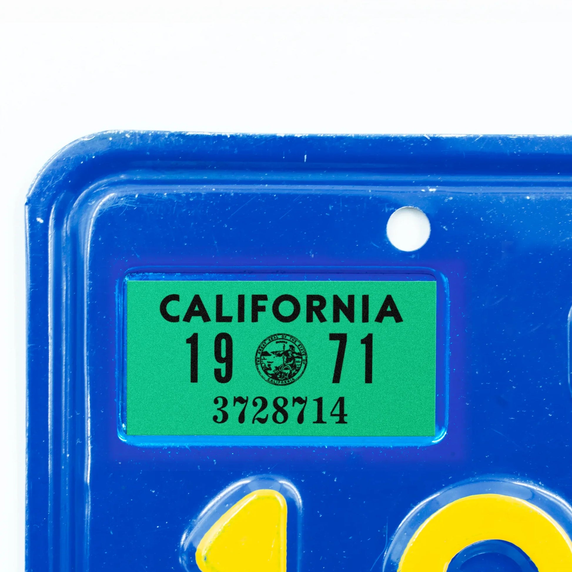 California license plate 1971 year sticker applied to upper corner of blue California plate — YOM Series