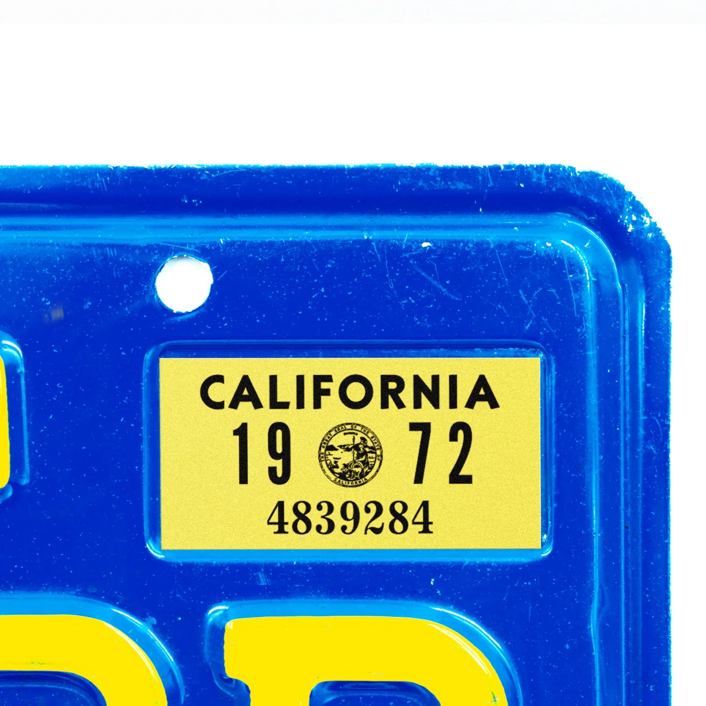 California license plate 1972 year sticker applied to upper corner of blue California plate — YOM Series