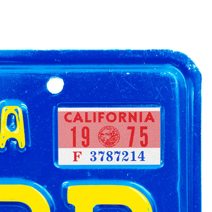 California license plate 1975 year sticker applied to upper corner of blue California plate — YOM Series