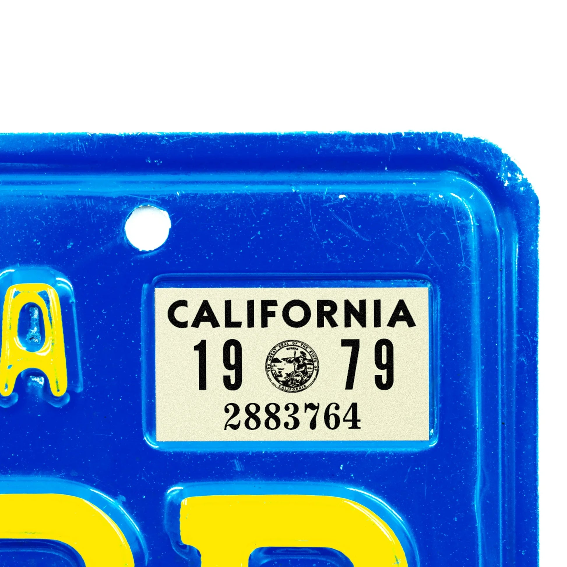 California license plate 1979 year sticker applied to upper corner of blue California plate — YOM Series