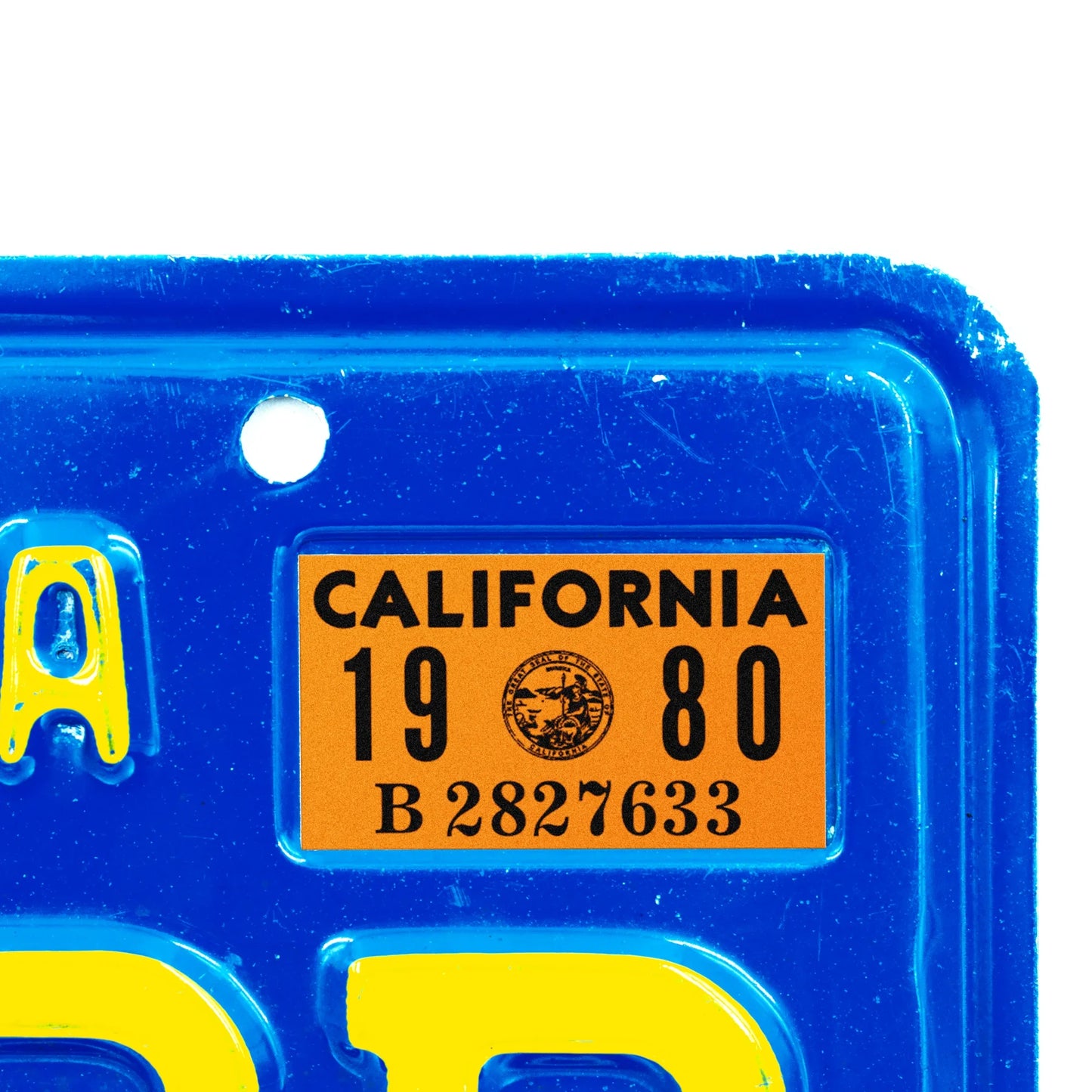 California license plate 1980 year sticker applied to upper corner of blue California plate — YOM Series