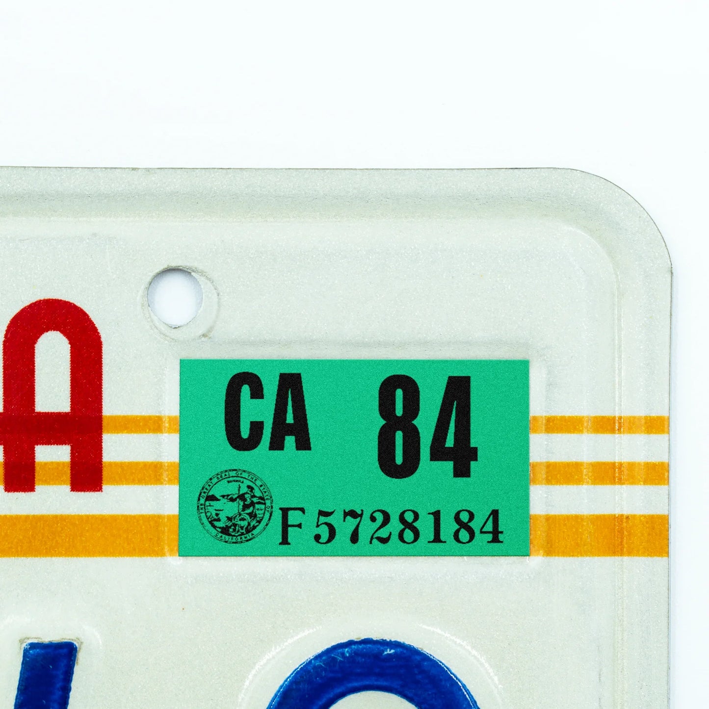 California license plate 1984 year sticker applied to upper corner of 1980s sunset California plate — Classic Series