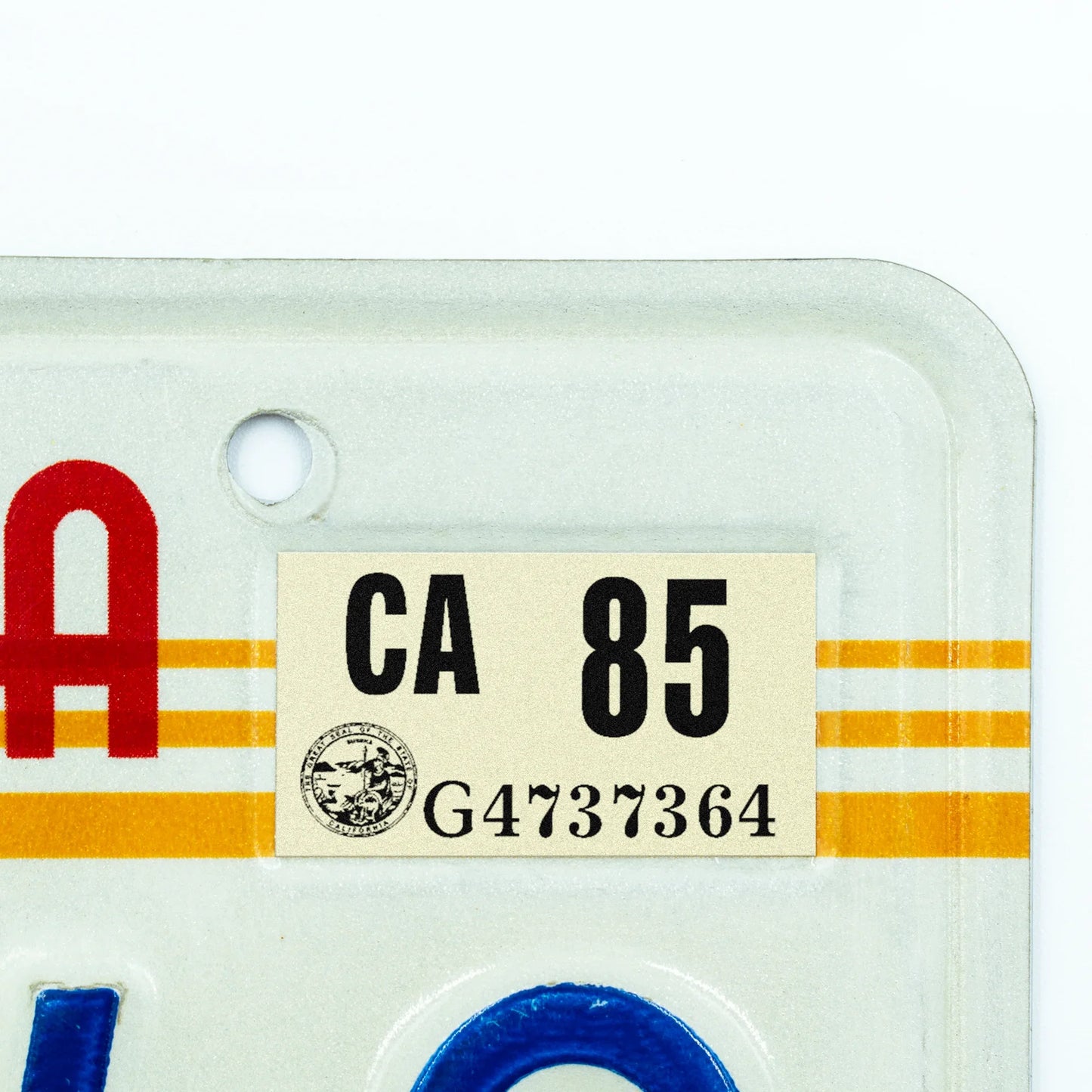 California license plate 1985 year sticker applied to upper corner of 1980s sunset California plate — Classic Series