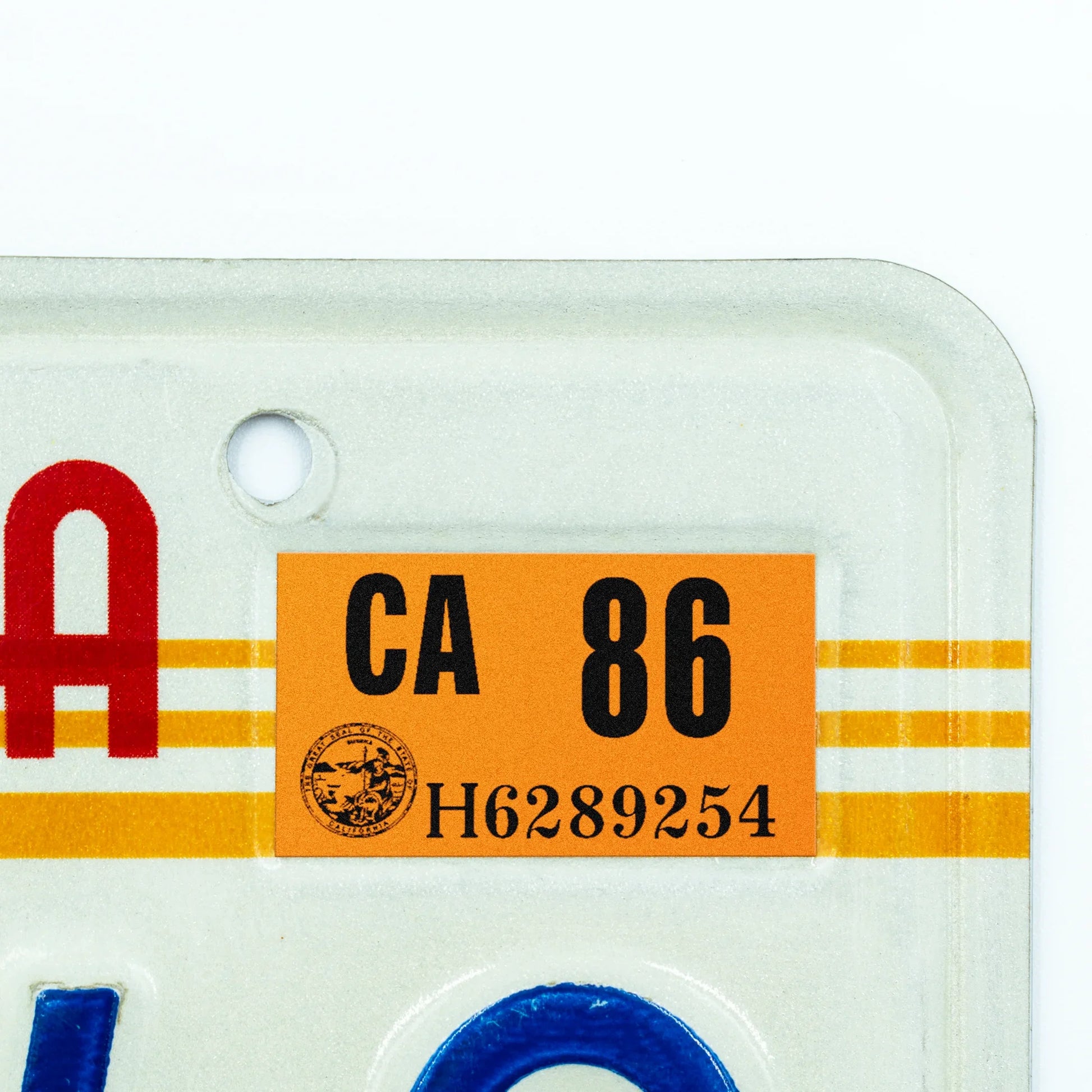 California license plate 1986 year sticker applied to upper corner of 1980s sunset California plate — Classic Series