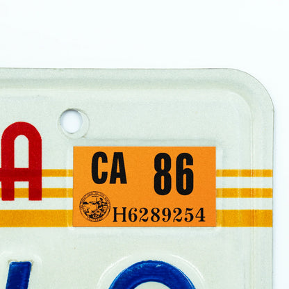 California license plate 1986 year sticker applied to upper corner of 1980s sunset California plate — Classic Series