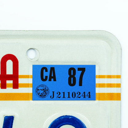 California license plate 1987 year sticker applied to upper corner of 1980s sunset California plate — Classic Series