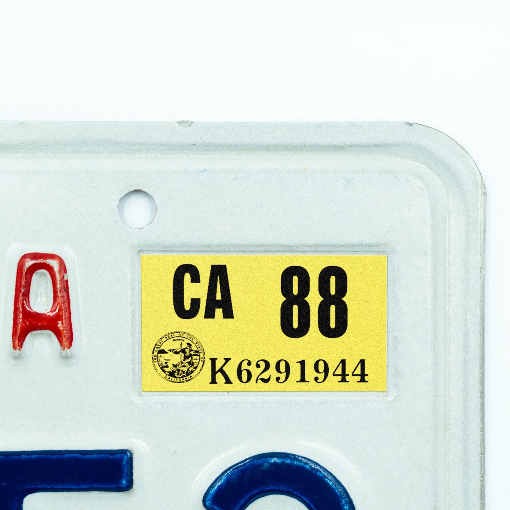 California license plate 1988 year sticker applied to upper corner of white California plate — Classic Series