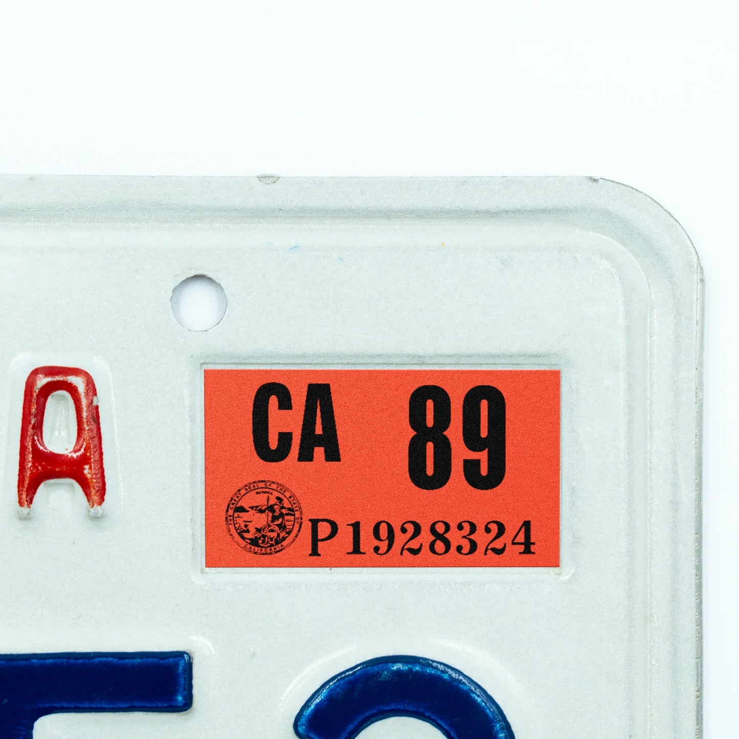California license plate 1989 year sticker applied to upper corner of white California plate — Classic Series