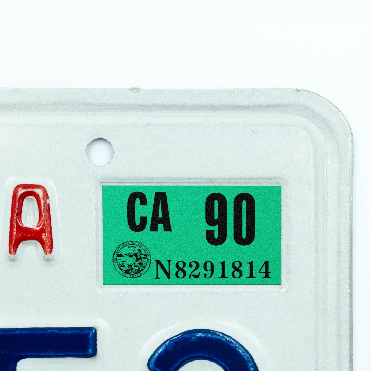 California license plate 1990 year sticker applied to upper corner of white California plate — Classic Series
