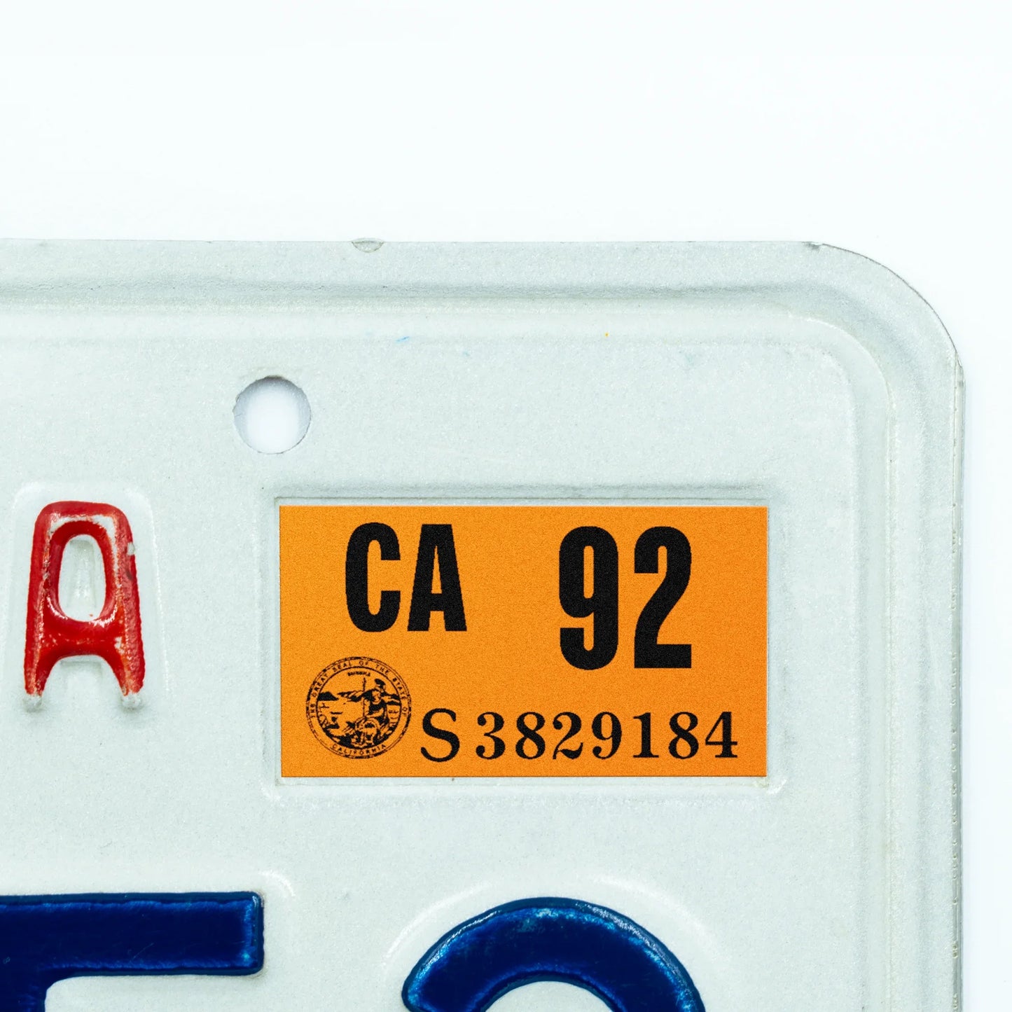 California license plate 1992 year sticker applied to upper corner of white California plate — Classic Series