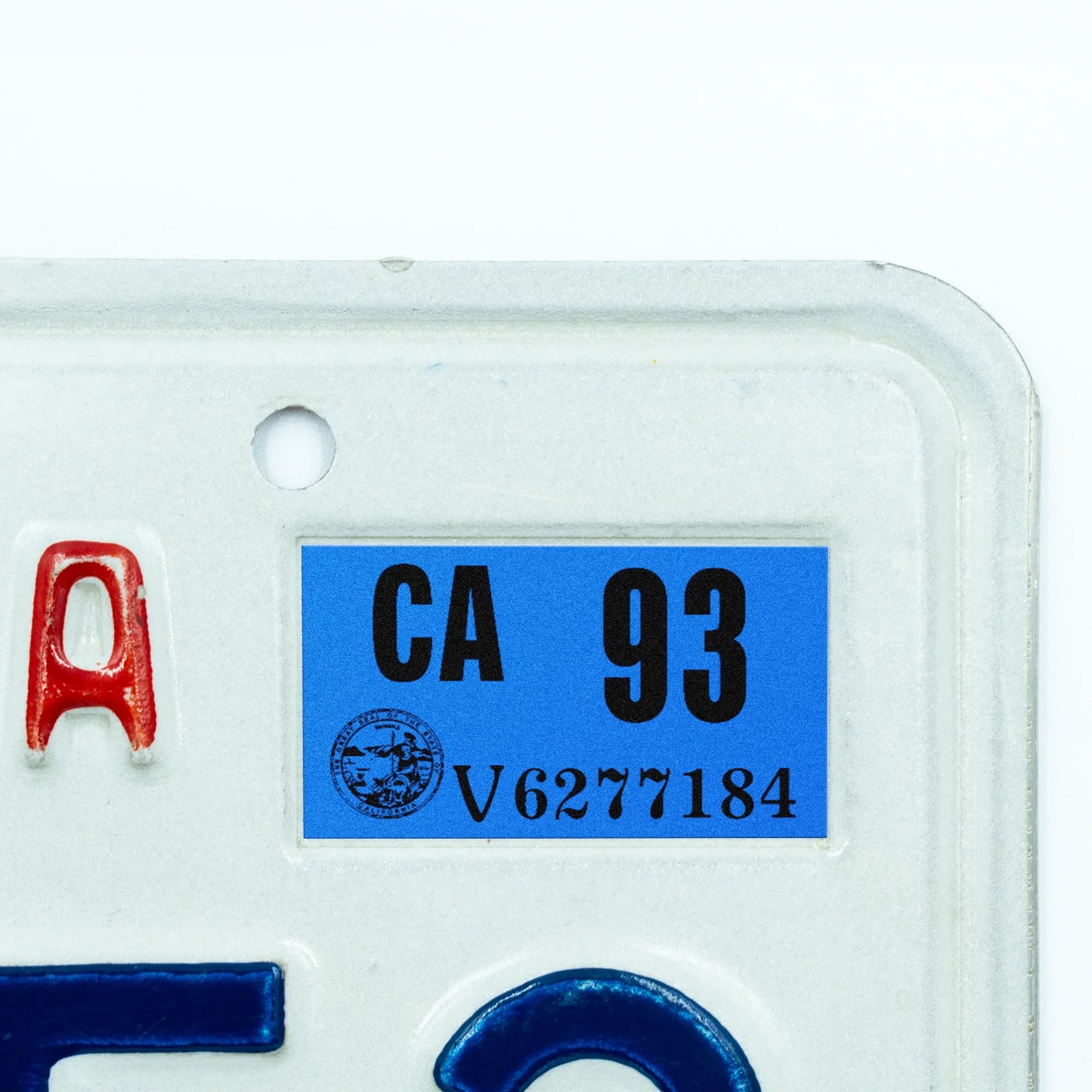 California license plate 1993 year sticker applied to upper corner of white California plate — Classic Series