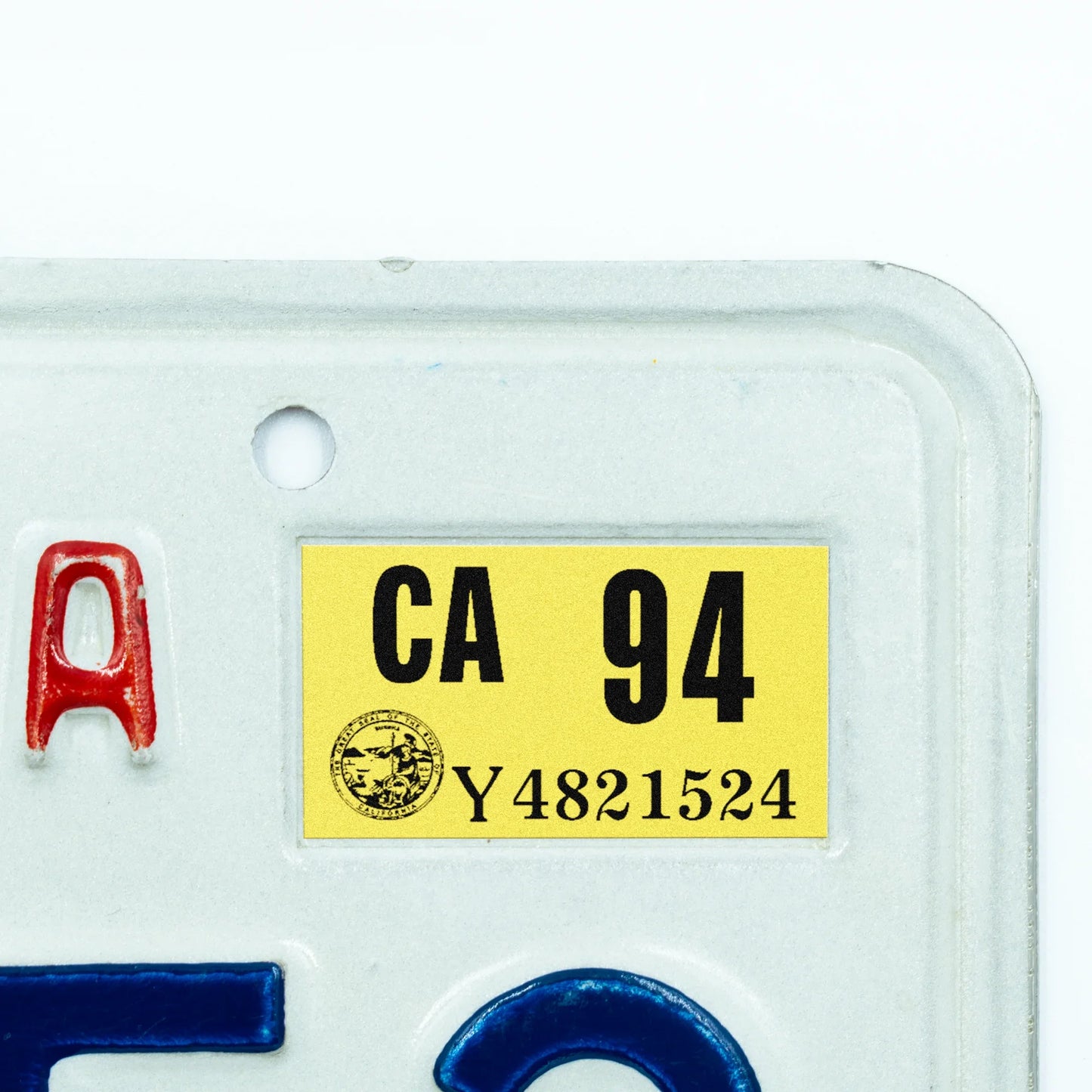 California license plate 1994 year sticker applied to upper corner of white California plate — Classic Series