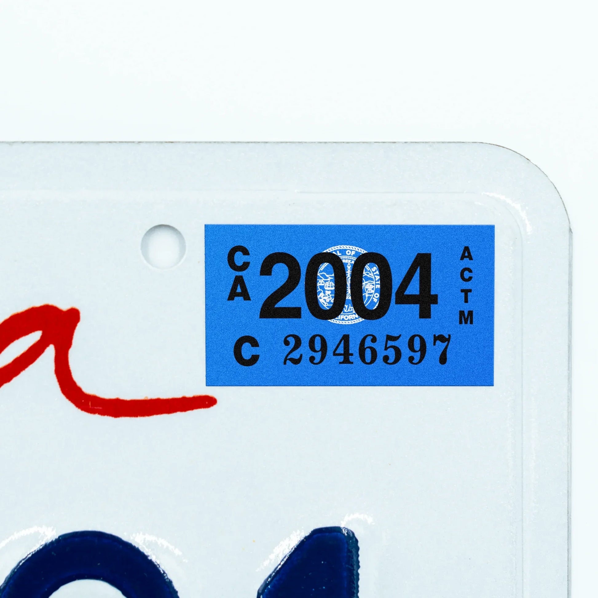 California license plate 2004 year sticker applied to upper corner of white California plate — Classic Series