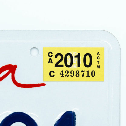 California license plate 2010 year sticker applied to upper corner of white California plate — Classic Series