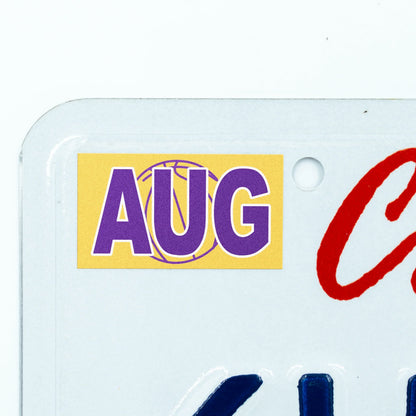 California license plate August month sticker applied to upper corner of white California plate — Courtside Series