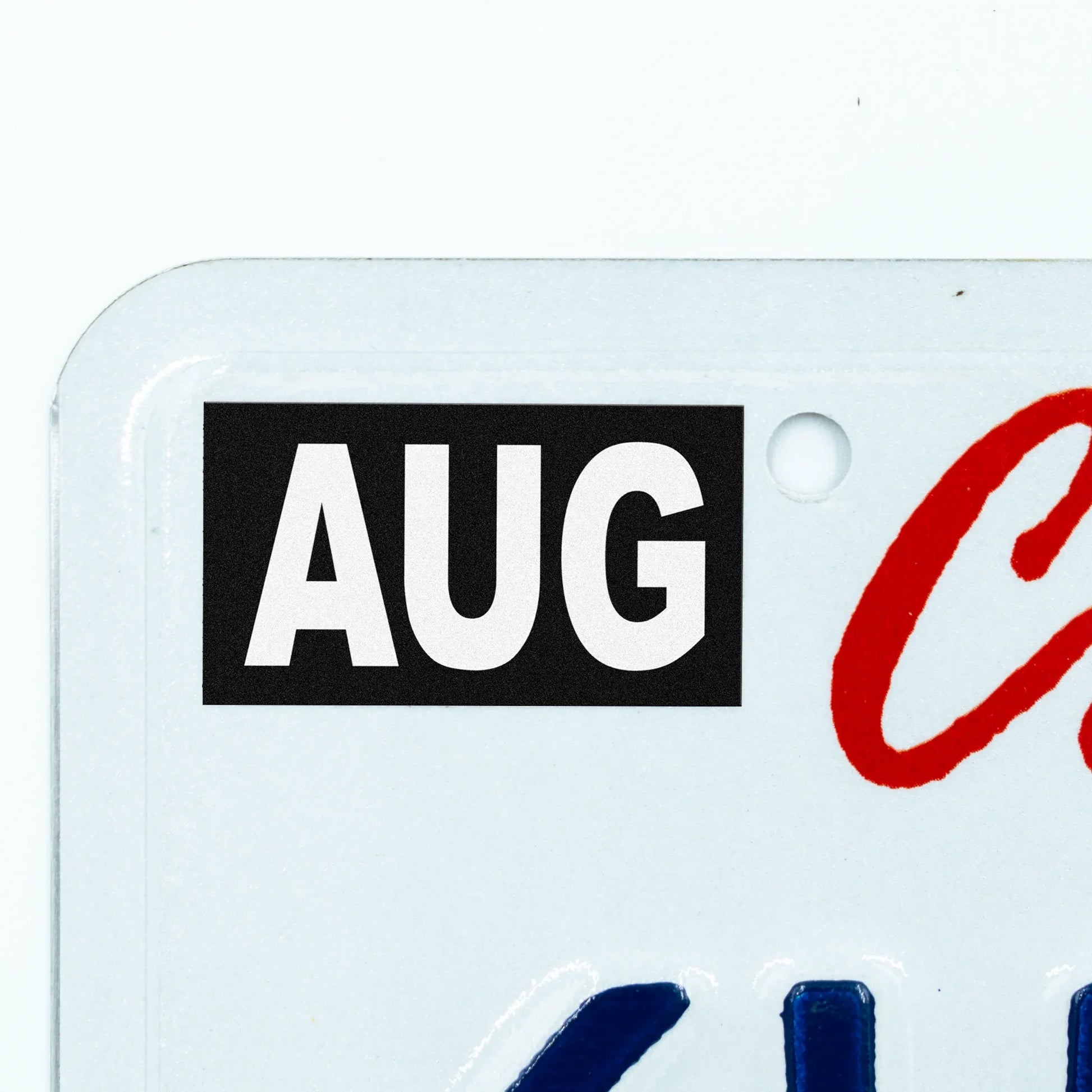 California license plate August month sticker applied to upper corner of white California plate — Stealth Series