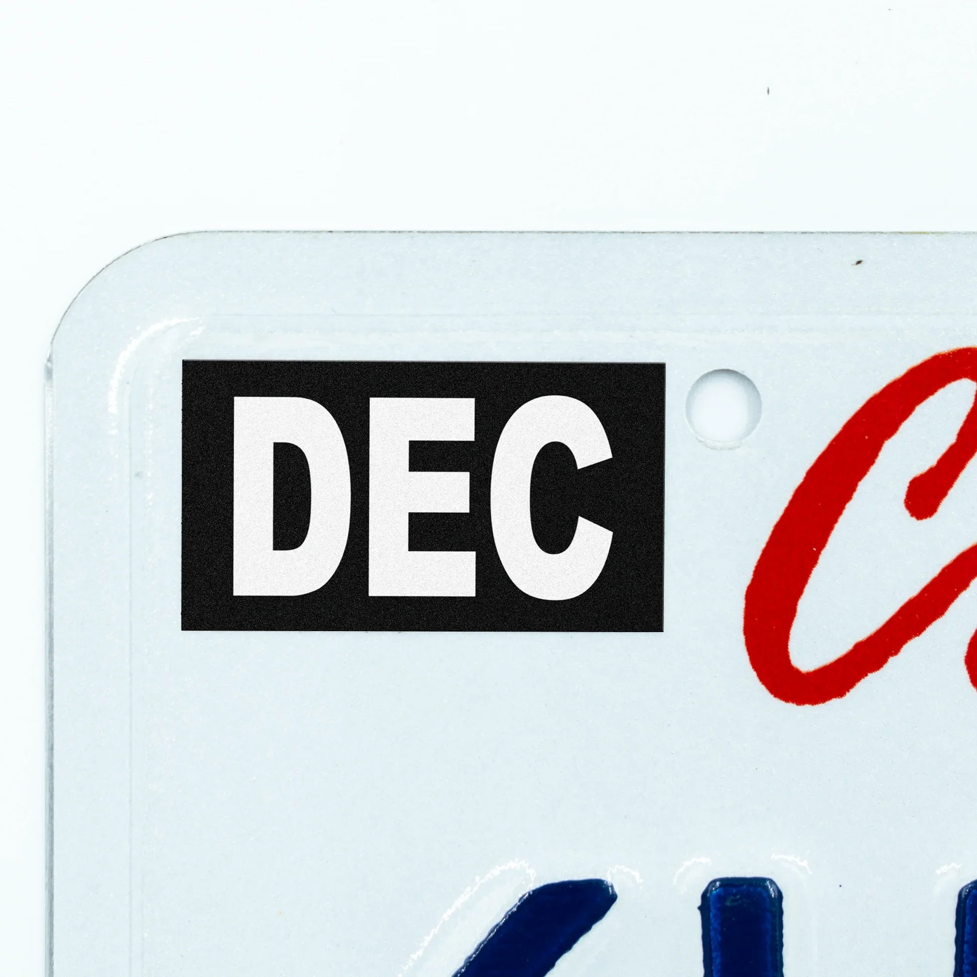 California license plate December month sticker applied to upper corner of white California plate — Stealth Series
