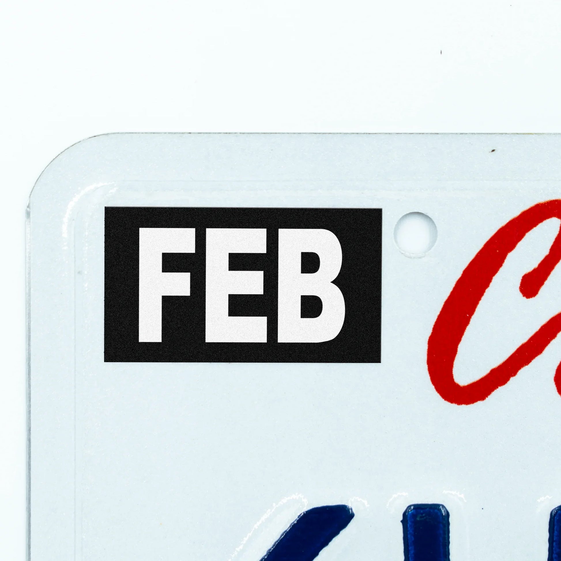 California license plate February month sticker applied to upper corner of white California plate — Stealth Series
