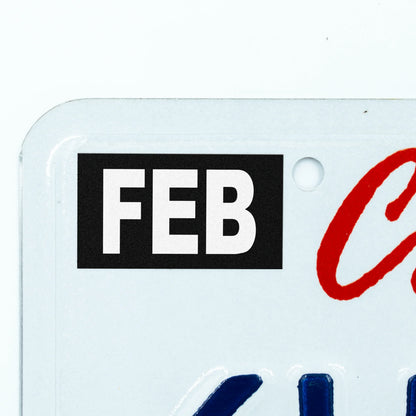 California license plate February month sticker applied to upper corner of white California plate — Stealth Series