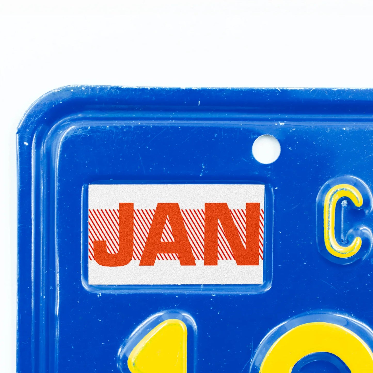 California license plate January month sticker applied to upper corner of blue California plate — Red Series