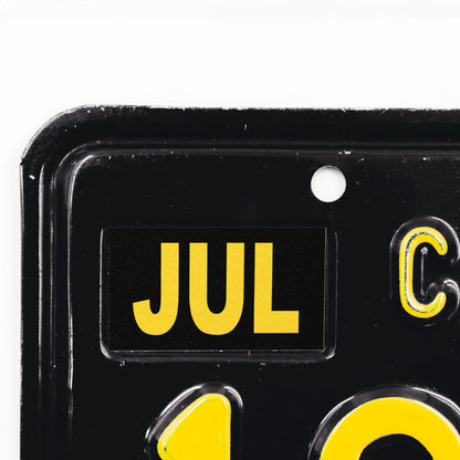 California license plate July month sticker applied to upper corner of black California plate — Legacy Series