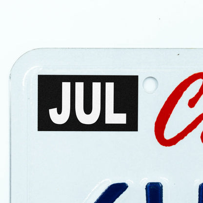 California license plate July month sticker applied to upper corner of white California plate — Stealth Series