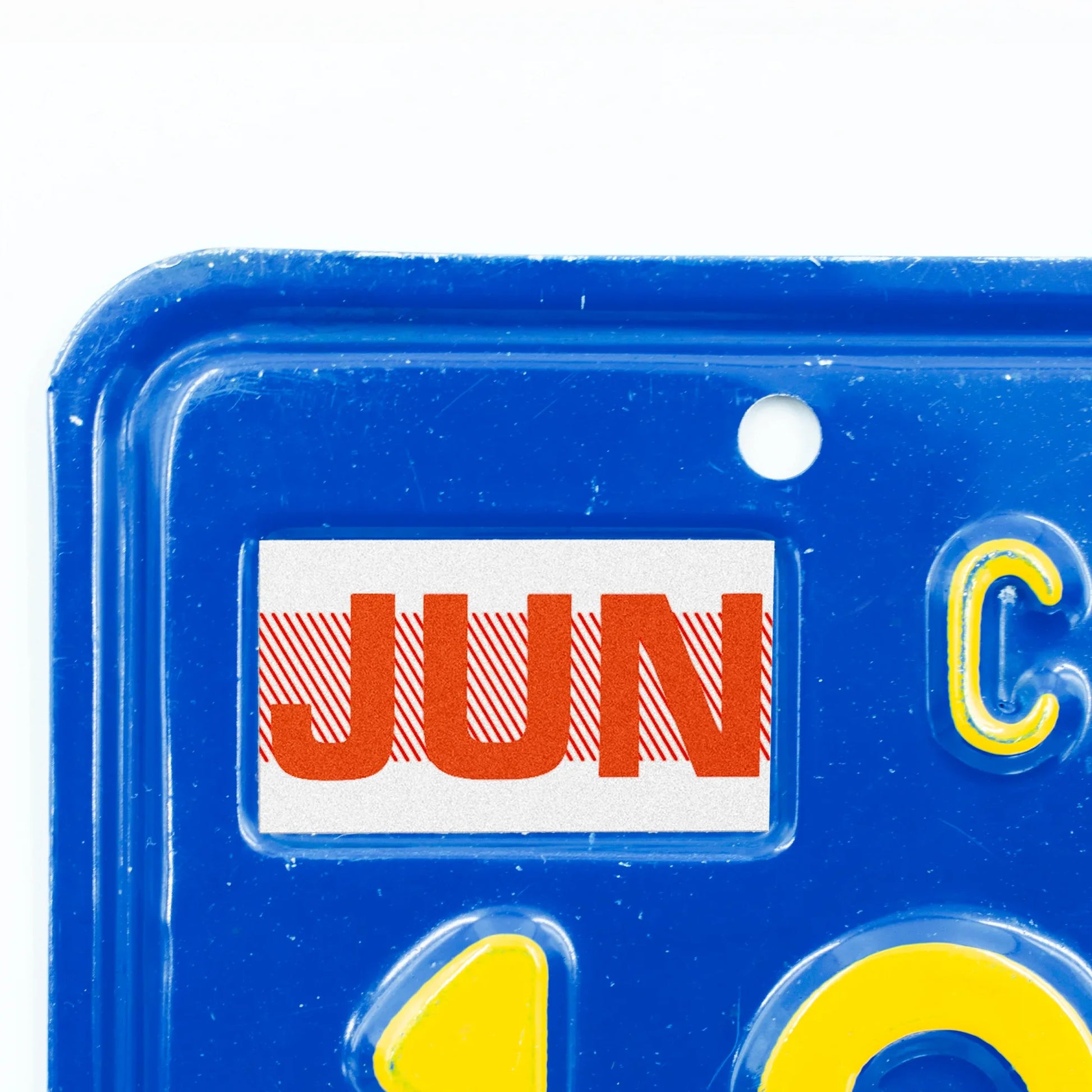 California license plate June month sticker applied to upper corner of blue California plate — Red Series