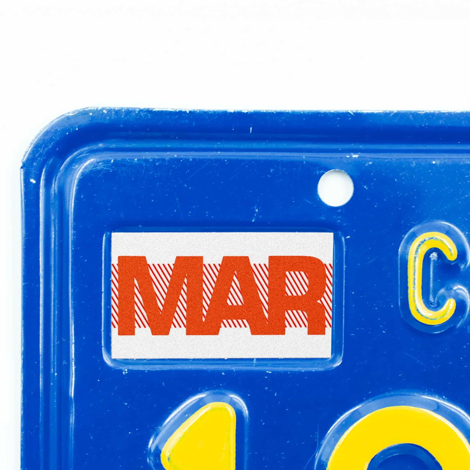 California license plate March month sticker applied to upper corner of blue California plate — Red Series