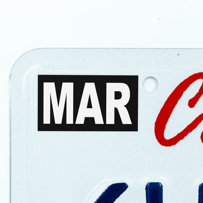 California license plate March month sticker applied to upper corner of white California plate — Stealth Series