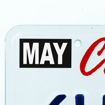 California license plate May month sticker applied to upper corner of white California plate — Stealth Series