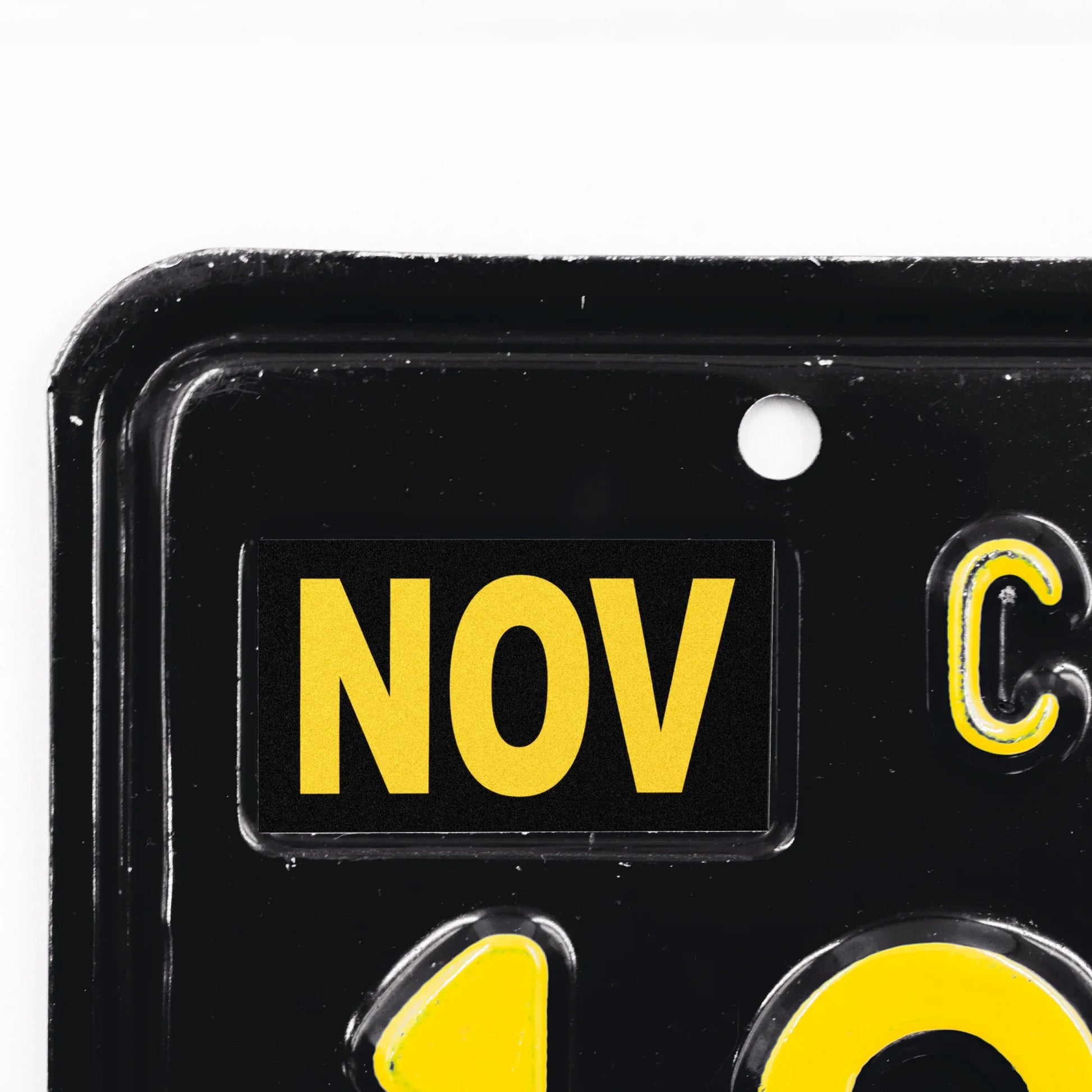 California license plate November month sticker applied to upper corner of black California plate — Legacy Series