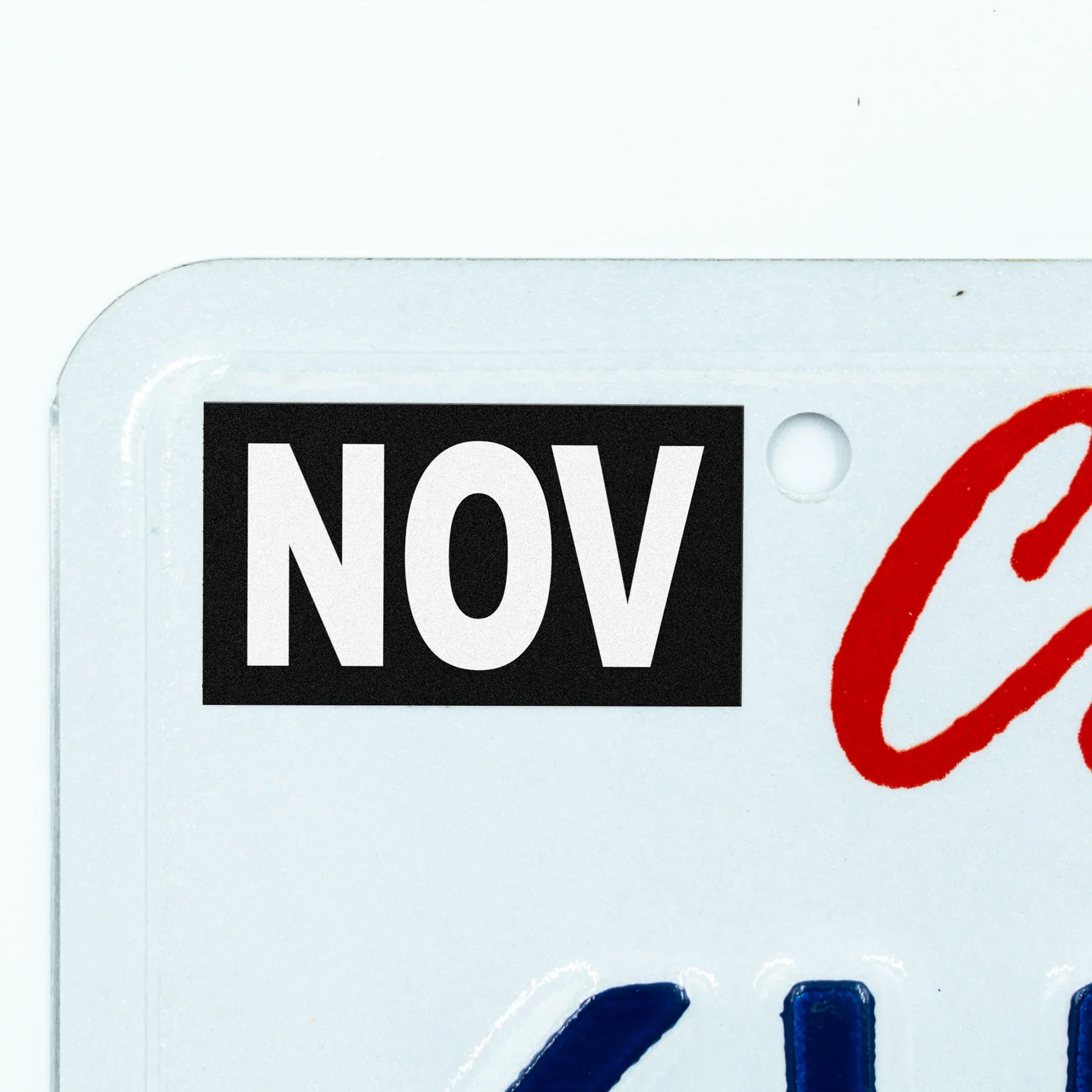 California license plate November month sticker applied to upper corner of white California plate — Stealth Series