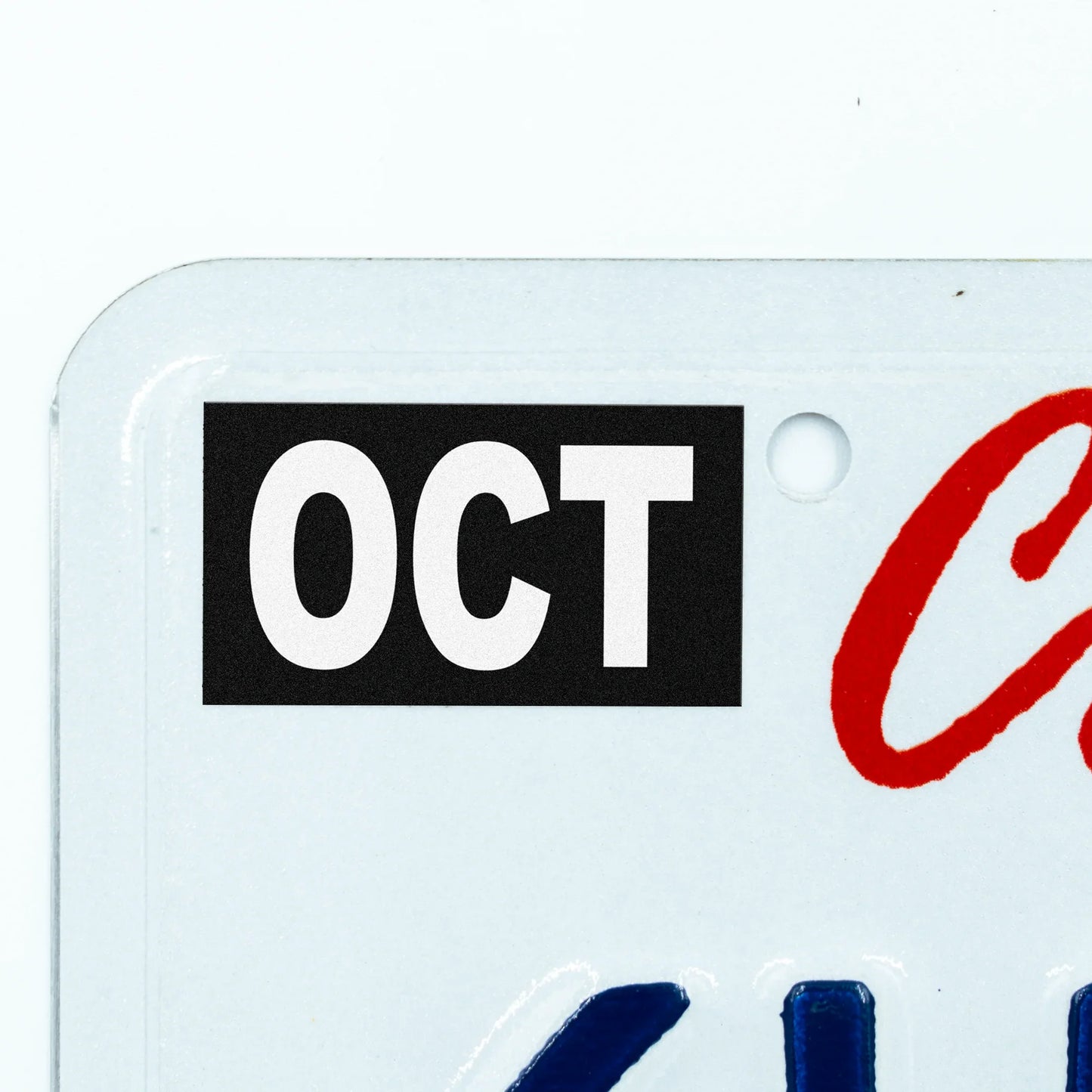 California license plate October month sticker applied to upper corner of white California plate — Stealth Series