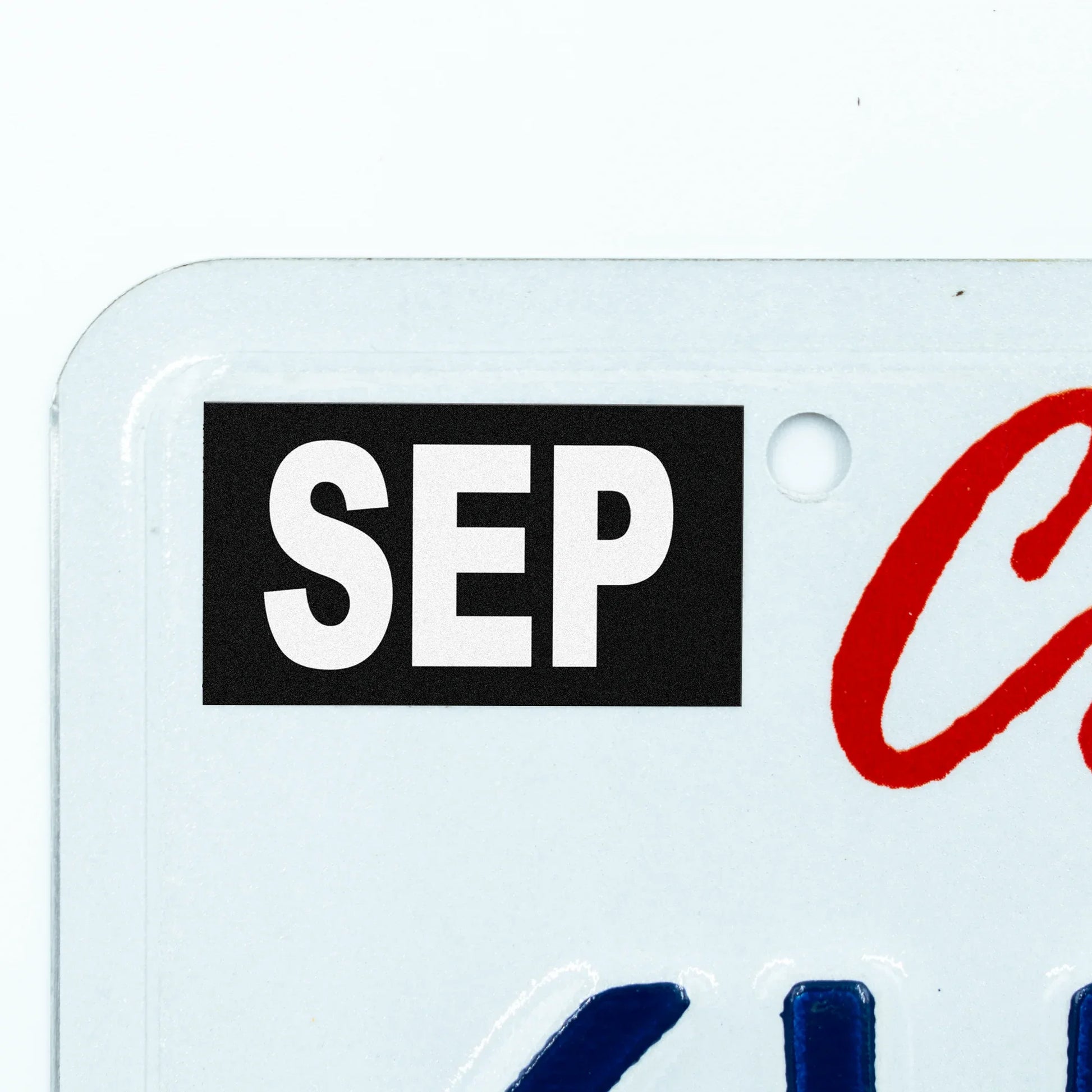 California license plate September month sticker applied to upper corner of white California plate — Stealth Series