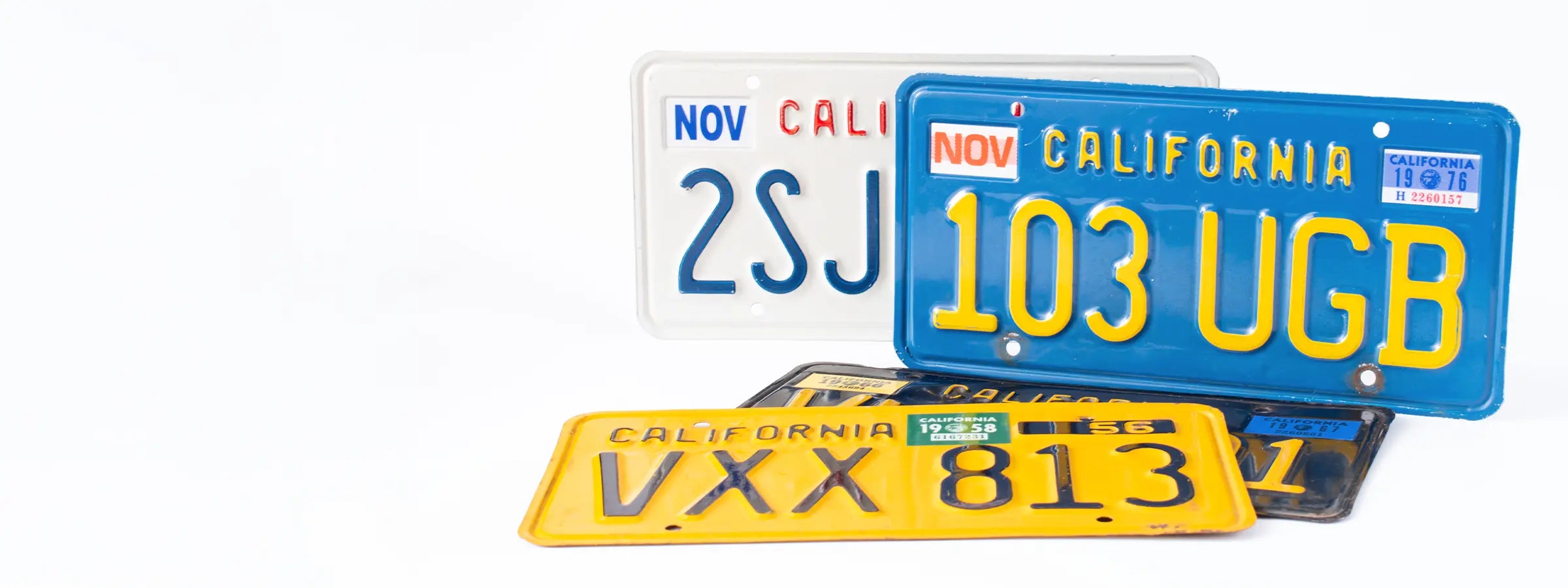 California license plates from multiple eras with registration month and year stickers