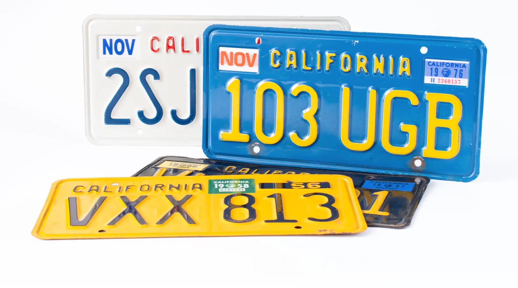 California license plates from multiple eras with registration month and year stickers